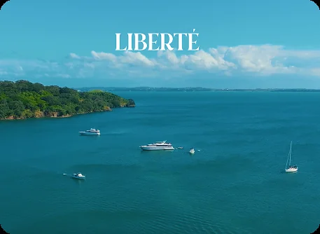Aerial view of Liberté anchored in a sheltered bay, for VIP yacht experiences from Auckland