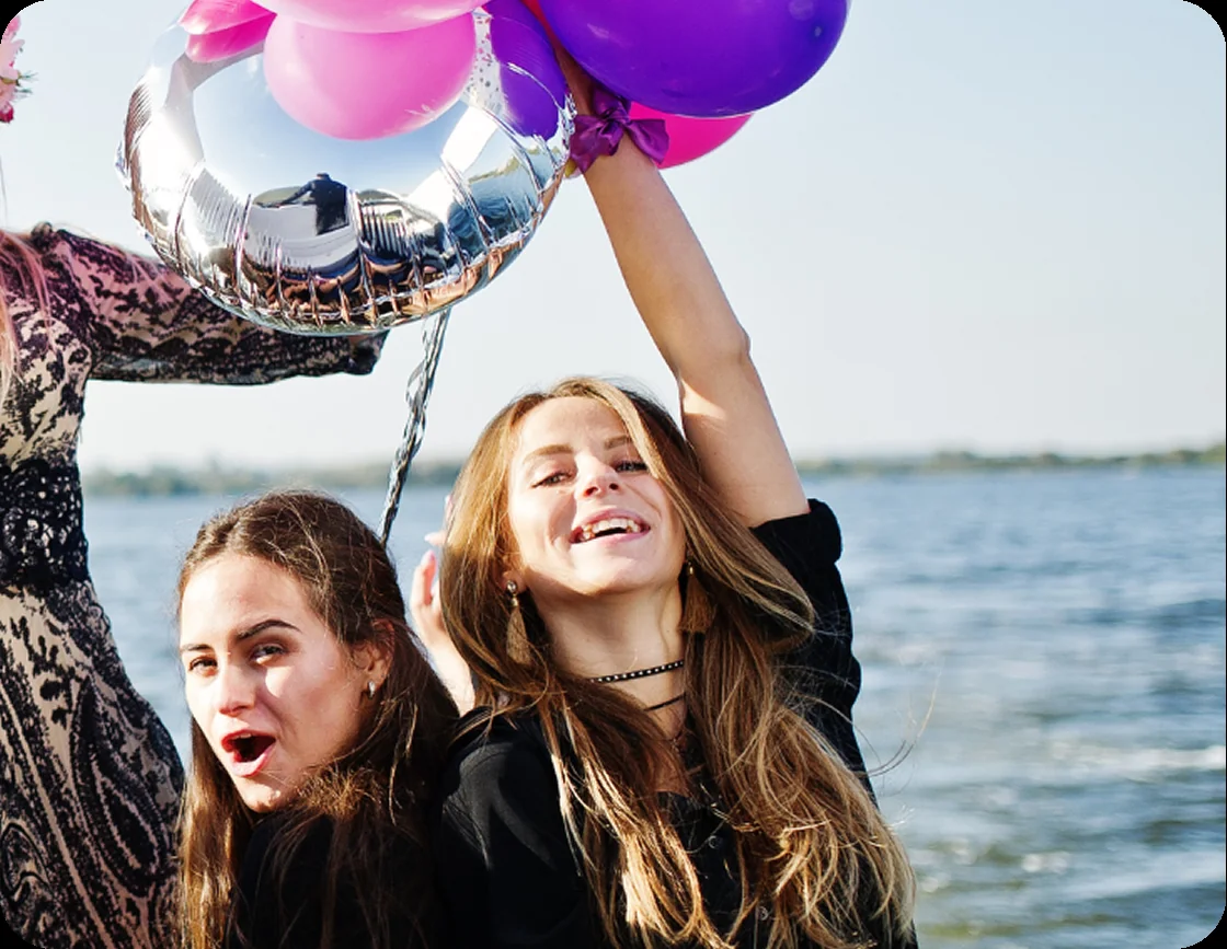 Guests with balloons celebrating a birthday on an Auckland yacht charter
