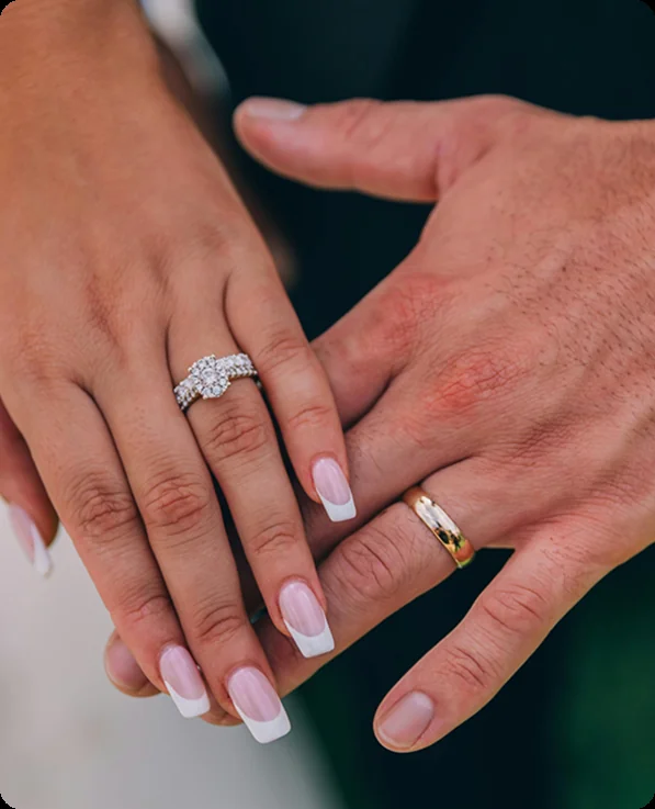 An engaged couple showing their rings, on a private yacht charter from Auckland