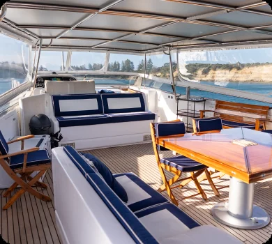 Liberté upper deck dining area, on a private yacht charter from Auckland