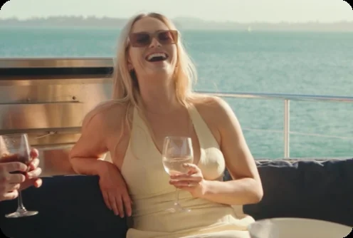 Guests raising a toast aboard Liberté, for hens party yacht charters in Auckland