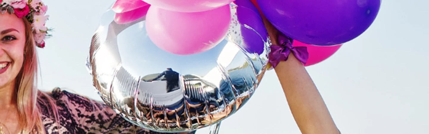 Guests with birthday balloons aboard an Auckland party yacht