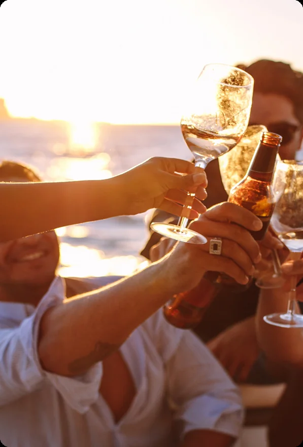 Guests raising a toast during a corporate yacht charter, on a private yacht charter from Auckland